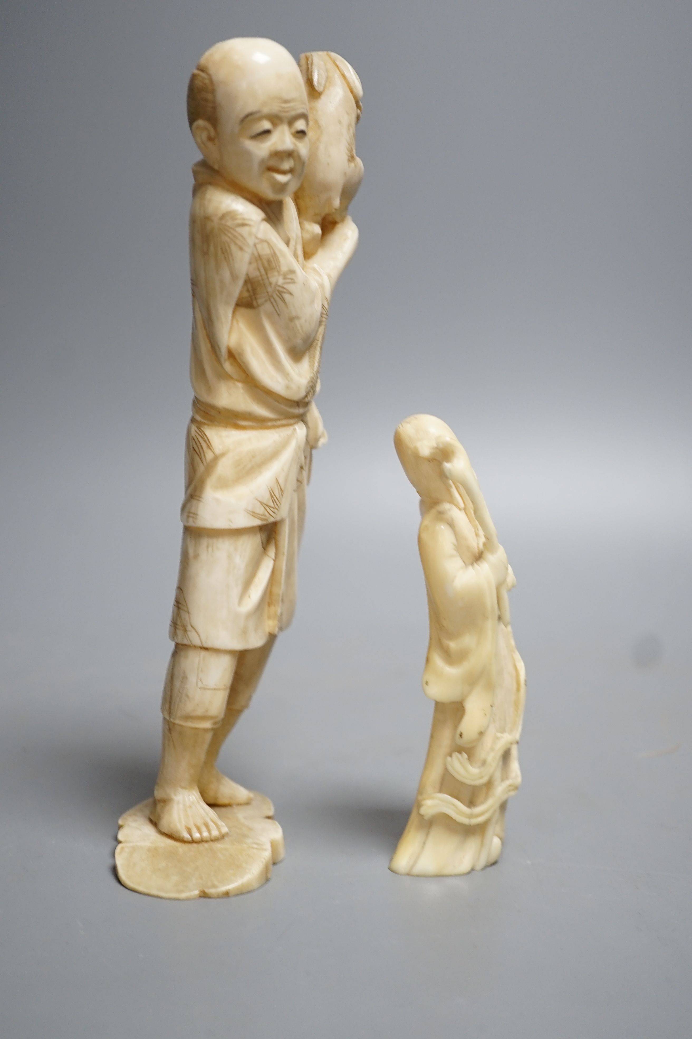 A 19th century Japanese ivory okimono of a man and rabbit together with an early 20th century hippo tooth? Carving of Shou Lao. Largest 19cm